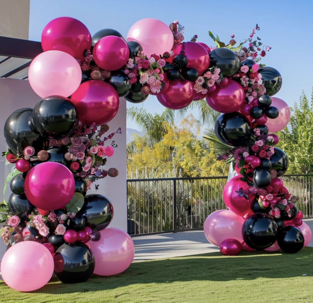 black and pink large balloon arch outdoors